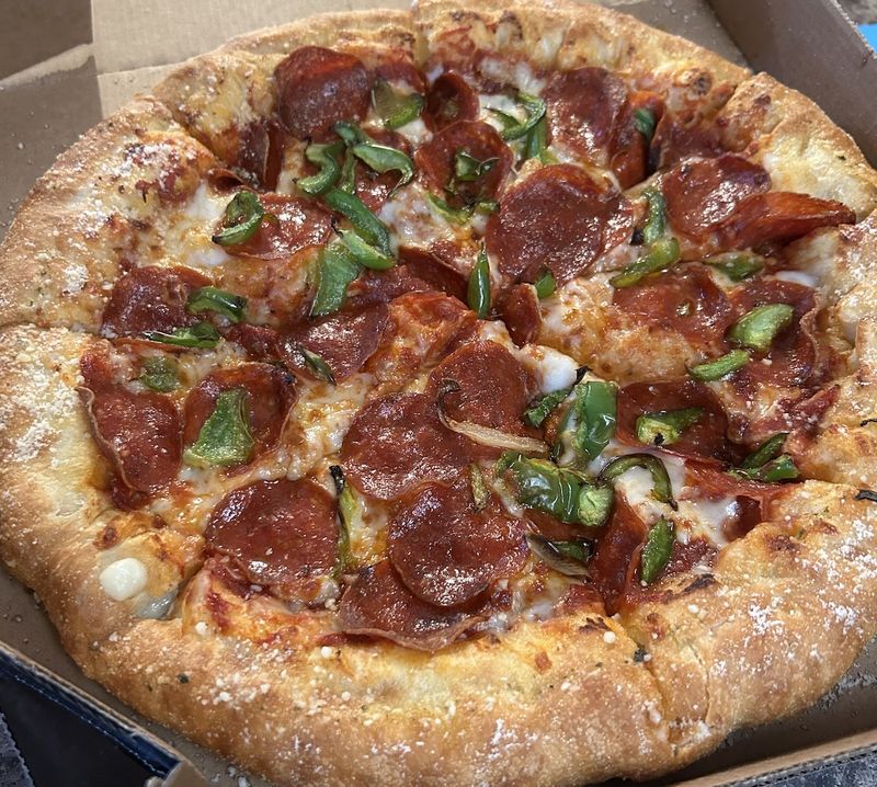 Photo of a Domino's stuffed crust pizza with pepperoni and green peppers.
